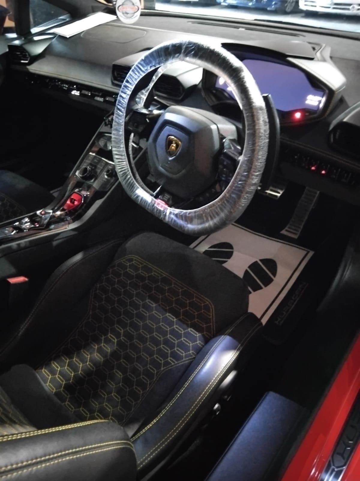 Lamborghini Huracán cabin with hexagon-stitched seats after an interior detail