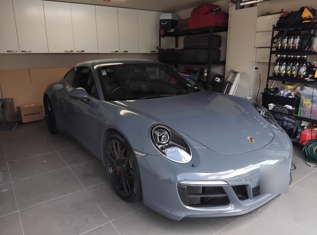 Grey Porsche 911 in a client garage after a detail